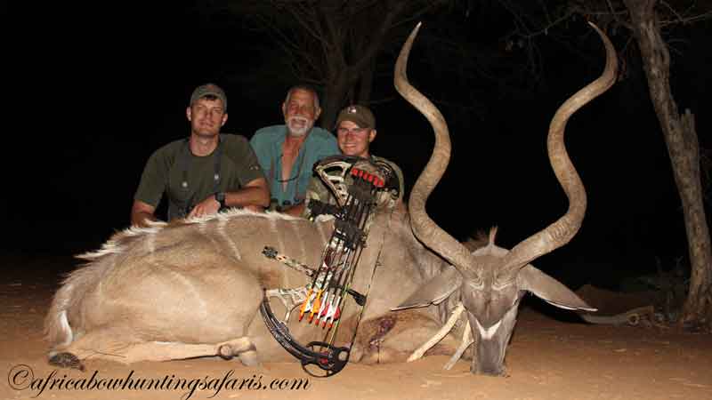 A father and two sons with a 56-inch greater kudu trophy bow hunted in South Africa
