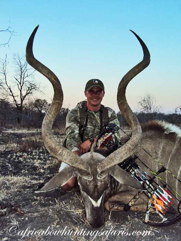 A young bow hunter with a trophy greater kudu bull harvested with a Matthews bow from a blind in North West, South Africa